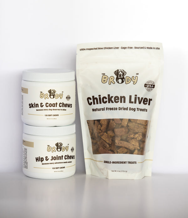 Three Brody Co dog treat products on a white background: two white jars labeled Skin & Coat Chews and Hip & Joint Chews, and one large white stand-up pouch labeled Chicken Liver Natural Freeze Dried Dog Treats.