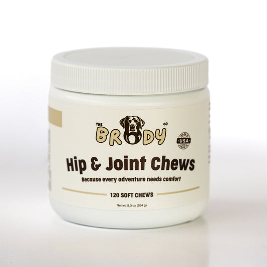 A white plastic jar of 'The Brody Co' Hip & Joint Chews for dogs, featuring a white screw-top lid and a cream-colored label with black and gold text.